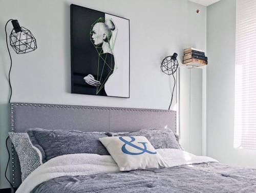 a bedroom with a bed with a picture on the wall at LakePark Artsy 3 bedroom Townhouse 1 Parking in Toronto