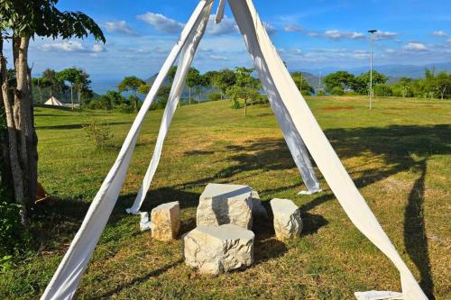an arch for a wedding in a field with rocks at The Hilltop Erawan in Si Sawat