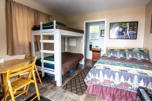 a bedroom with a bunk bed and a desk at Cabin 2 Lynn View Lodge in Haines