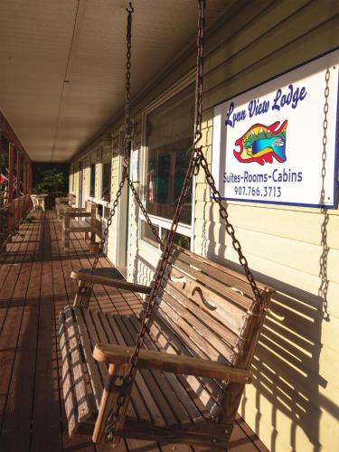a swinging bench outside of a fish store at Suite 2 Lynn View Lodge in Haines