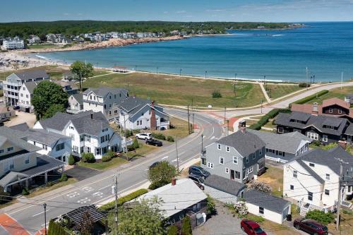 an aerial view of a town with houses and the ocean at Main House at One Long Beach in York Beach