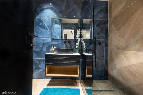 a bathroom with a sink and a mirror at Naomi Boutique Suites in Netu'a