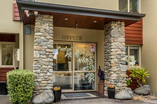 a store front of an office with a sign on it at Tussock Peak Lodge in Hanmer Springs