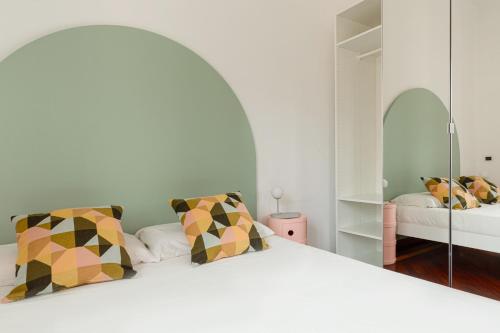 a bedroom with a large white bed with a mirror at Spacebility Expo - self check-in in Cagliari