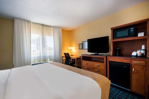 a hotel room with a bed and a flat screen tv at Quality Inn & Suites Bozeman in Bozeman