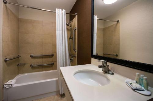 a bathroom with a sink and a tub and a shower at Quality Inn & Suites Bozeman in Bozeman