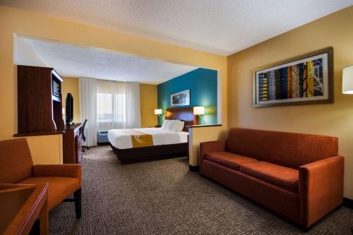 a hotel room with a bed and a couch at Quality Inn & Suites Bozeman in Bozeman