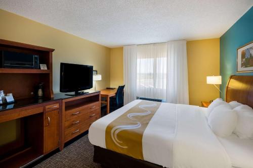 a hotel room with a bed and a flat screen tv at Quality Inn & Suites Bozeman in Bozeman