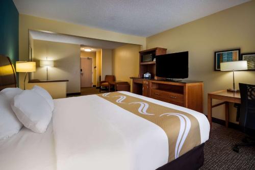 a hotel room with a bed and a flat screen tv at Quality Inn & Suites Bozeman in Bozeman