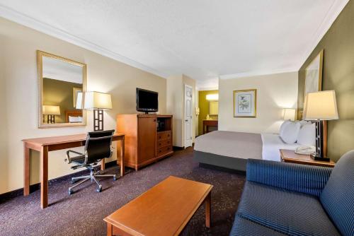 a hotel room with a bed and a desk at Quality Inn Morgan City in Morgan City