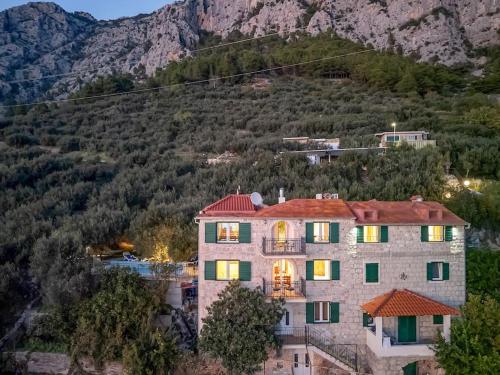 a large house on the side of a mountain at Villa Sanja - Makarska Exklusiv in Makarska