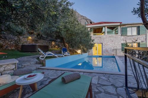 a backyard with a swimming pool and a house at Villa Sanja - Makarska Exklusiv in Makarska
