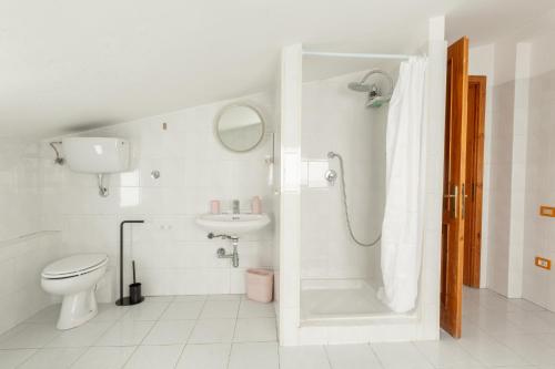 a bathroom with a toilet and a shower and a sink at Spacebility Airport - self check-in in Cagliari