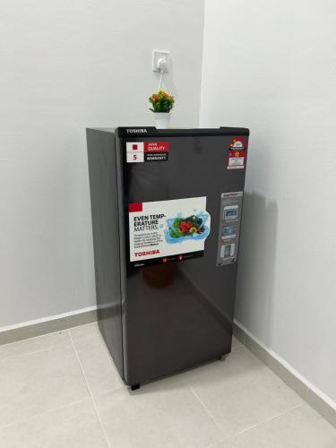 a small refrigerator with a sign on the side of it at Ct Wani Homestay in Wakaf Baharu