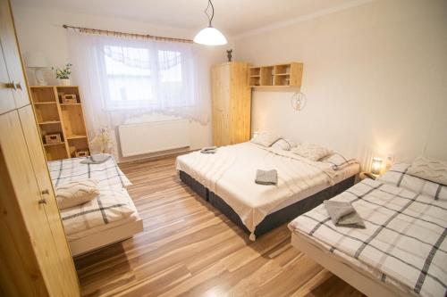 a bedroom with two beds and a window at One Floor under High Tatras in Malý Slavkov