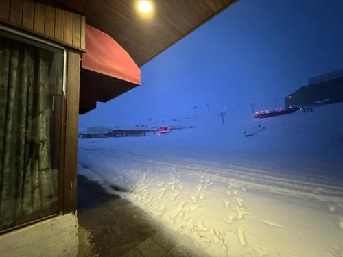 a view of a snow covered street at night at Giorgi Apartment In New Gudauri - Block 3 - N315 in Gudauri