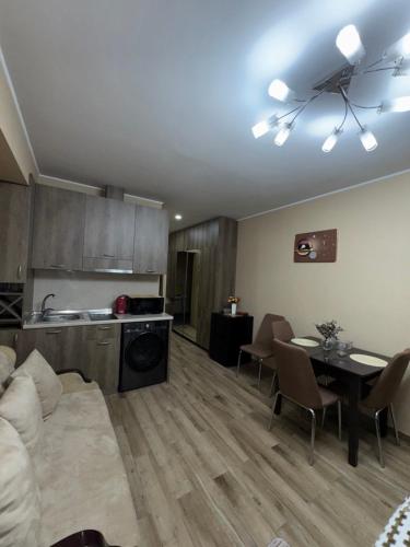 a living room with a couch and a table at Giorgi Apartment In New Gudauri - Block 3 - N315 in Gudauri