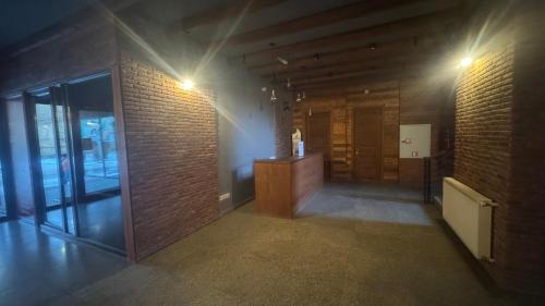 an empty room with a brick wall and a desk at Giorgi Apartment In New Gudauri - Block 3 - N315 in Gudauri