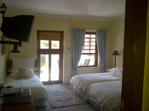 Ένα ή περισσότερα κρεβάτια σε δωμάτιο στο Agulhas Country Lodge