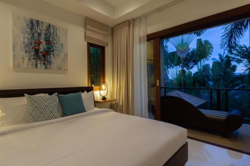 a bedroom with a bed and a large window at 4 Secluded Villas Private Resort in Nathon Bay