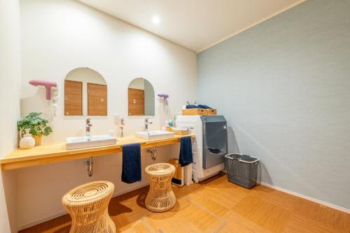 a kitchen with two sinks and two stools at すずかのおやど Suzuka Inn in Suzuka