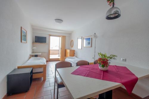 a living room with a dining room table and a living room at TOP Appartamenti in Passo del Tonale