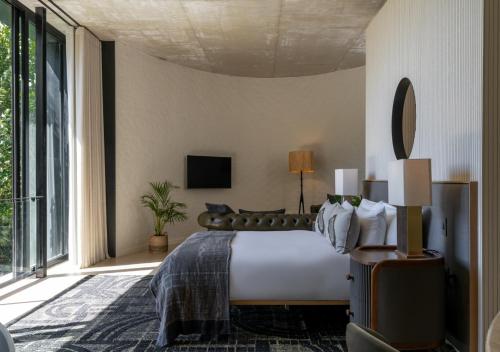a bedroom with a bed and a large window at Future Found Sanctuary, Luxury Boutique Hotel by NEWMARK in Cape Town