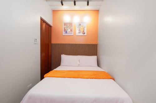 a small bedroom with a bed in a room at Unit 102 - Your Cozy Batangas Retreat in Batangas City