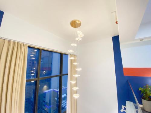 a room with a large window and a ceiling with lights at X - The Nordic - Icon City Petaling Jaya in Sungai Way