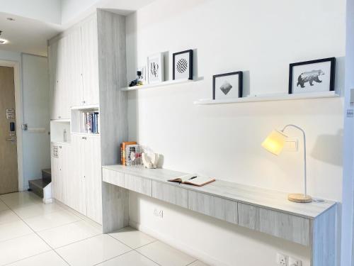 a room with a desk with a lamp and books at X - The Nordic - Icon City Petaling Jaya in Sungai Way