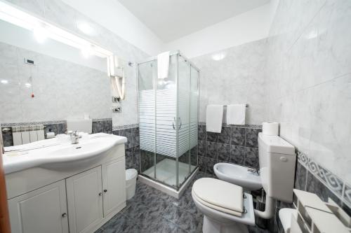 a bathroom with a sink and a toilet and a shower at Hotel Cavour Resort in Moncalieri