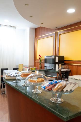 a kitchen with a counter with wine glasses on it at Hotel Cavour Resort in Moncalieri
