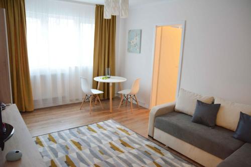 a living room with a couch and a table at SMP Apartment in Timişoara