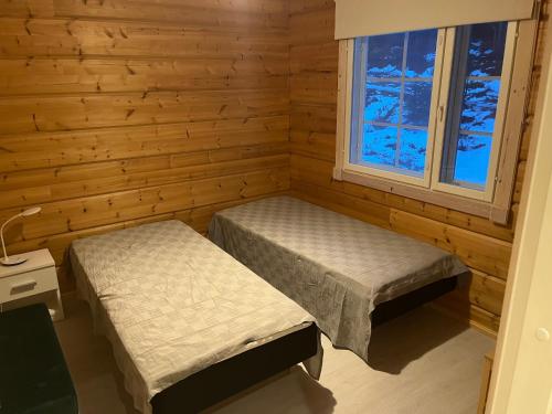 Katil atau katil-katil dalam bilik di Villa Tunturikajo at Iso-Syöte