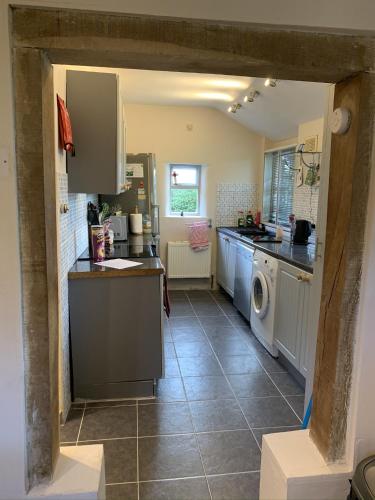 a kitchen with a sink and a dishwasher at Myrtle cottage in Dickleburgh