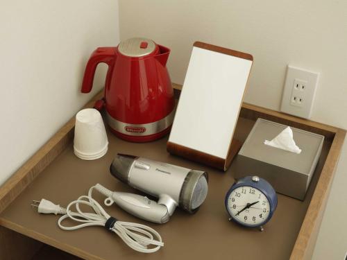 a counter top with a blender and a alarm clock at Smart Place Inn Kyoto Shijo Omiya Station in Kyoto