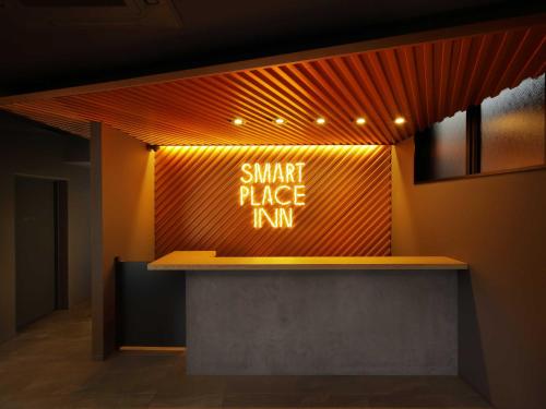 a sign that says smart place inn on a wall at Smart Place Inn Kyoto Shijo Omiya Station in Kyoto