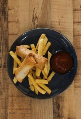 a blue plate with fries and a container of ketchup at Tullah Lakeside Lodge in Tullah
