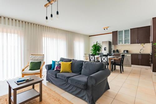 a living room with a couch and a table at Bela Vista Family in Praia de Mira
