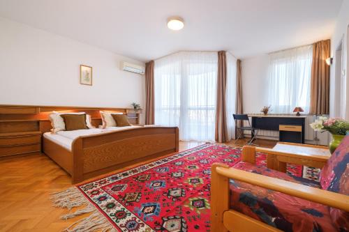 a bedroom with a bed and a living room at The Hill House Free Parking in Plovdiv
