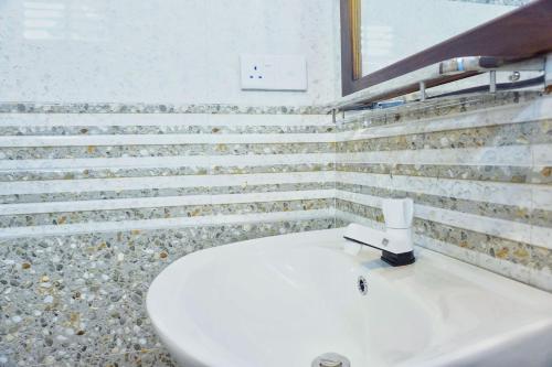 a bathroom with a white toilet and a sink at Sky Villa Sigiriya in Sigiriya
