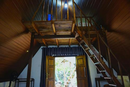 a staircase in a room with a ceiling at Sky Villa Sigiriya in Sigiriya