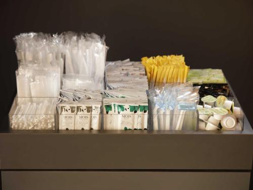 a shelf with a bunch of plastic bags and other items at Smart Place Inn Kyoto Nijojo-mae Station in Kyoto