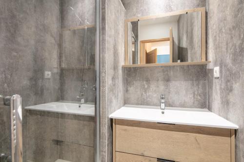 a bathroom with a sink and a mirror at L'Etoile des Neiges - Station de ski à pied in Chamrousse