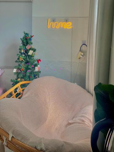 a room with a bed and a christmas tree at Homestay Tuyết Trinh in Nha Trang