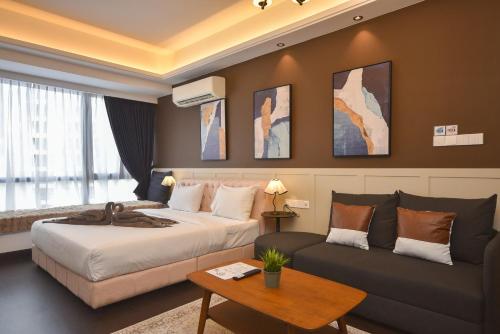 a hotel room with a bed and a couch at R&F Princess Cove by Nest Home at Johor Bahru in Johor Bahru