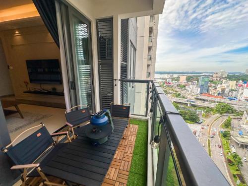 a balcony with chairs and a table on a balcony at R&F Princess Cove by Nest Home at Johor Bahru in Johor Bahru