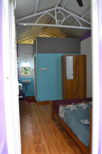 a bedroom with a bunk bed and a bathroom at SS Tiny Home Stays in Kolli Hills