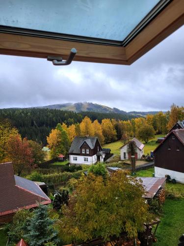 a view of a farm from the window of a house at Velflík - ubytování v srdci Krušných hor in Abertamy