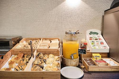 a table with two boxes of food and a bottle of orange juice at Hotel Ciudad de Compostela in Santiago de Compostela